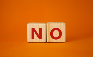 No symbol. Concept words No on wooden blocks. Beautiful orange background. Business and No concept. Copy space.