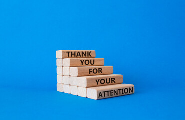 Attention symbol. Wooden blocks with words Thank you for your attention. Beautiful blue background. Business and Thank you for your attention concept. Copy space.