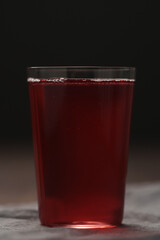 berry drink in thin glass on wood table