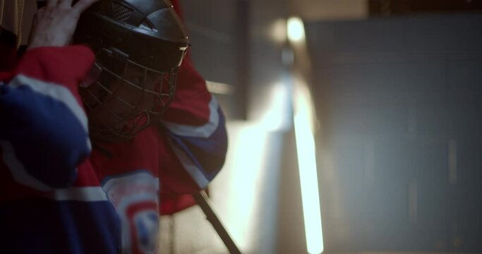 Closeup of a hockey player getting ready in the changing room for a game