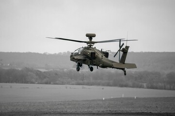 Attack helicopter performing low level hover maneuver