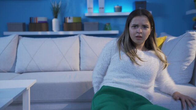 The mentally ill young woman becomes paranoid and flees the camera in doubt and fear.
The camera makes the paranoid and schizophrenic young woman suspicious and frightened.
