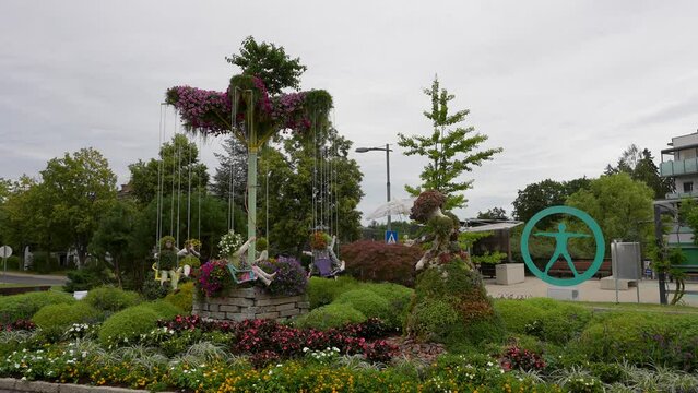 Beautiful view of a flower theme park with a floral wave swinger and floral children