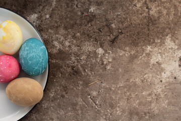 Easter eggs lie on the background, space for text