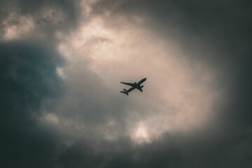 Low angle shot of a plate silhouette flying in a clear sky