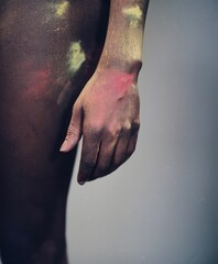 Vertical shot of an African man with colorful powders