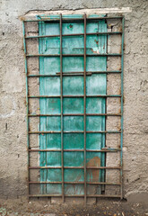Industrial door behind metal bars concrete wall