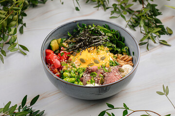 Portion of gourmet poke bowl with beef pastrami vegetables