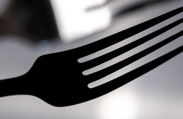 The shadow of the fork in close-up.