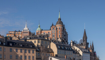 Old apartment houses on the cliff Mariaberget with towers and dorms, a sunny spring morning in Stockholm 