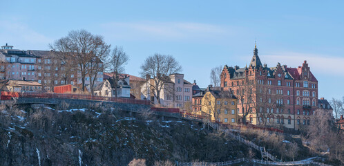 Old 1700s homestead houses on the cliff Mariaberget, at the bay Riddarfjärden, a sunny spring day in Stockholm