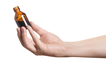 Hand holding a vial with dark liquid, cut out