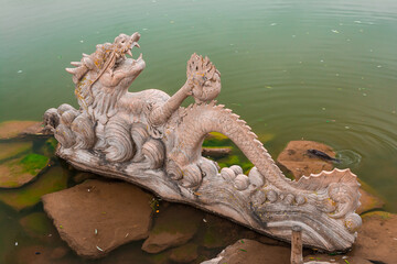 Stone dragon statue in the lake