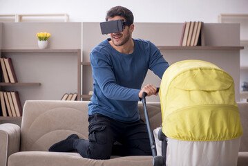 Young male contractor looking after baby at home