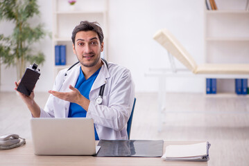 Young male doctor enjoying virtual glasses in the clinic