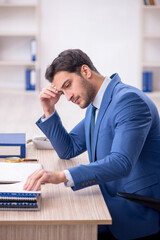 Young male employee working in the office