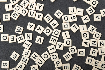 English alphabet made of square white tiles on grey background. English language learning concept....
