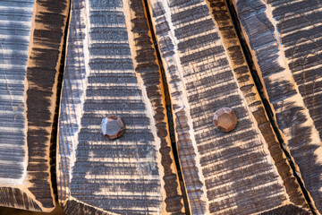 Dark grunge wood paneling background close up. Rough old wooden surface with scuffs