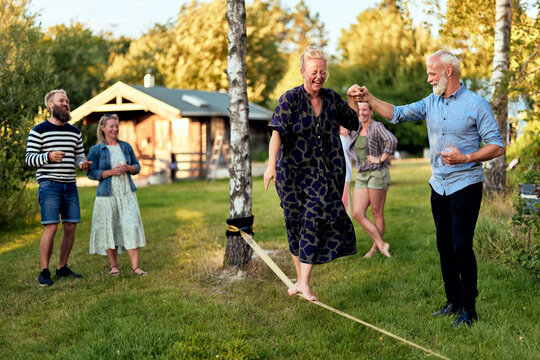 Mature woman laughing on a slack line