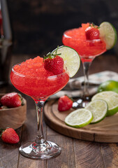 Frozen strawberry daiquiri cocktail with strawberries and lime
