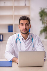 Young male doctor in telemedicine concept