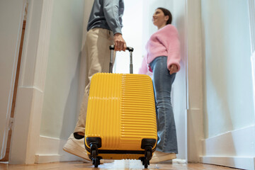 Fototapeta na wymiar Unrecognizable Tourists Couple Entering Hotel Room, Selective Focus On Suitcase