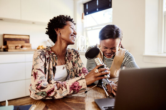 Friends laughing while doing a podcast