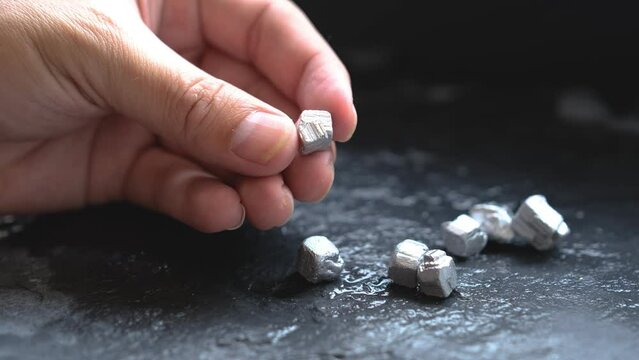 Miners hold in their hands platinum or silver or rare earth minerals found in the mine for inspection and consideration	

