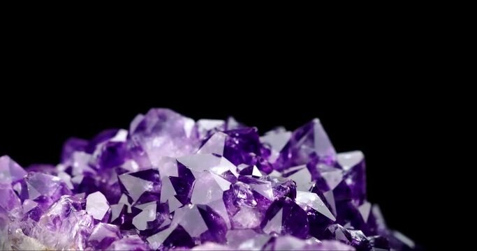 dark crystal amethyst druse 360&deg; rotation in 4k. macro detail texture background. close-up raw rough unpolished semi-precious gemstone