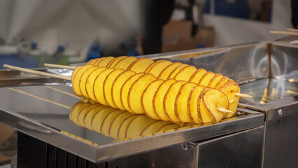 Fried potato chips on skewers. Close-up. Street food. Fast food