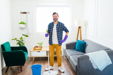 Attractive man ready to start mopping the floor at home
