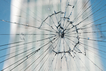 Broken glass, glass cracked from an accident on a blurred building background