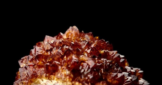 heated amethyst (citrine) druse 360&deg; rotation in 4k. macro detail texture background. close-up raw rough unpolished semi-precious gemstone