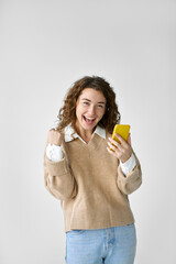Young happy lucky woman student feeling excited winner looking at cellphone using mobile phone...