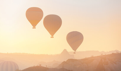Landscape sunrise in Cappadocia with set colorful hot air balloon fly in sky with sun light. Concept tourist travel Goreme Turkey
