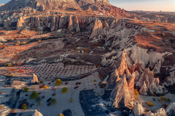Panoramic view of Goreme national park with over deep canyons, valleys sunset Cappadocia. Popular Turkey touristic destination, aerial top view drone