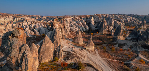 Autumn landscape Cappadocia horse with riding and old cave house in Goreme national park Turkey, aerial top view