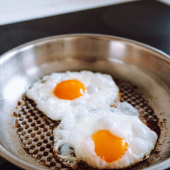 Burnt scrambled eggs in metal pan