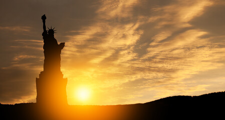 Silhouettes of The Statue of Liberty at sunset. Greeting card for Independence Day.