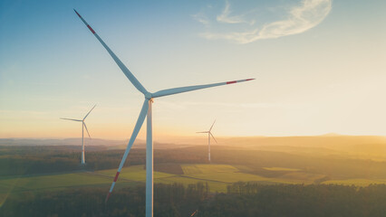 High angle View of wind turbines over the field at sunset 