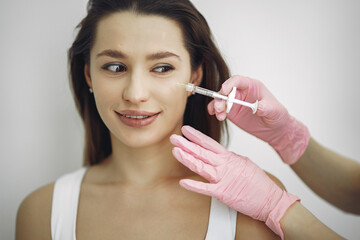 Woman with a doctor in cosmetology studio