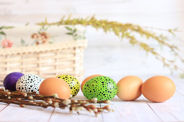 Easter eggs close-up on a wooden table and willow twigs. Painted Easter eggs are a traditional symbol of a religious holiday. Christian traditions of celebration