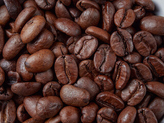 Antique vintage retro bronze coffee mill on black wooden board with roasted coffee beans