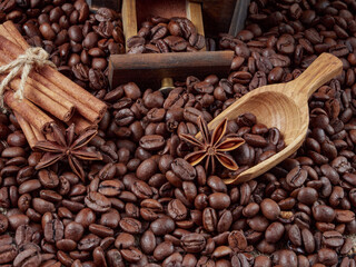 Antique vintage retro bronze coffee mill on black wooden board with roasted coffee beans
