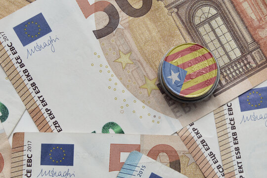 euro coin with national colorful flag of catalonia on the euro money banknotes background