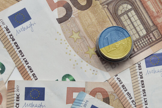 euro coin with national flag of ukraine on the euro money banknotes background