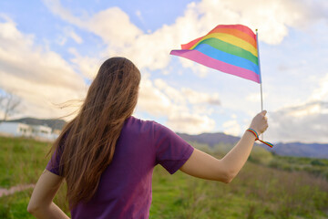 Woman with small LGTB flag in her hand