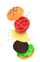 plasticine food. levitating plasticine burger isolated on transparent background png. cutlet, tomato, lettuce leaves, bun are made of plasticine