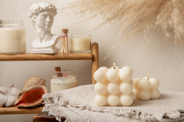 Obraz na płótnie Canvas Cozy decor and burning candles against the backdrop of a minimalist interior. Trendy Bubble candles with vanilla flavor. Eco soy candles. Candles for relaxation. Close-up. Place for text. Interior. Hy