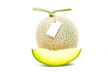 Green melon with white tag on white background. Fruit and nature food background
